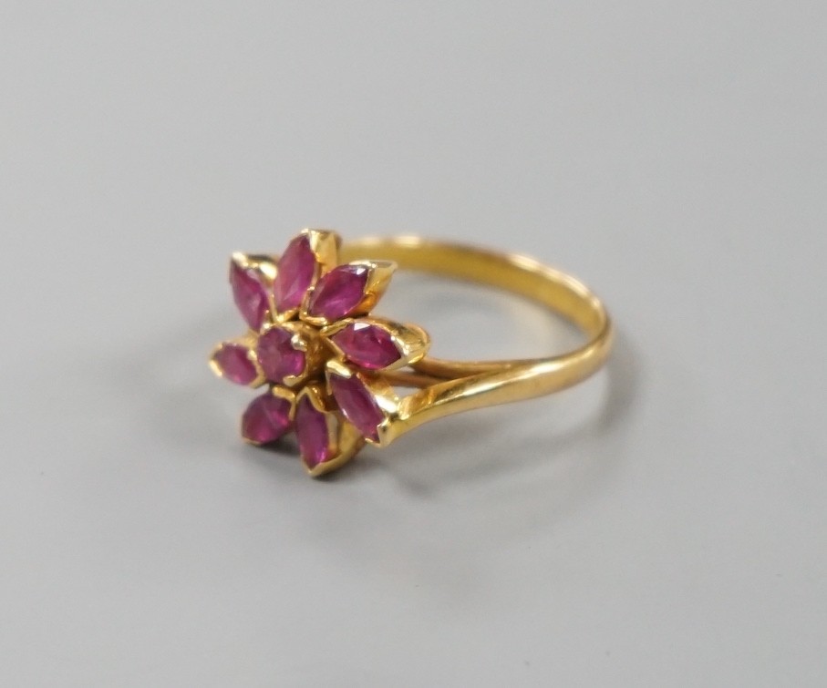 A continental yellow metal and ruby cluster set ring, size K, gross weight 3.1 grams.